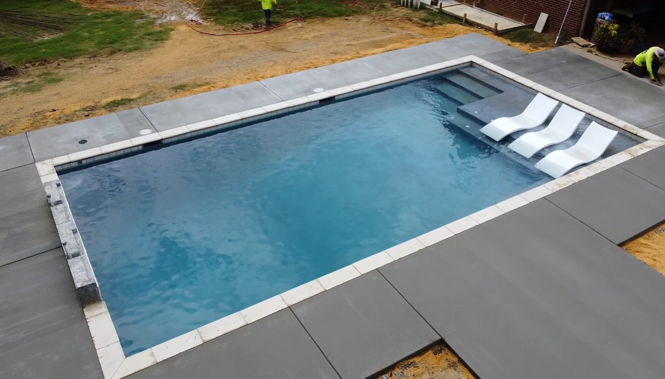 Professional concrete contractor working on pool deck installation in Goldsboro, NC